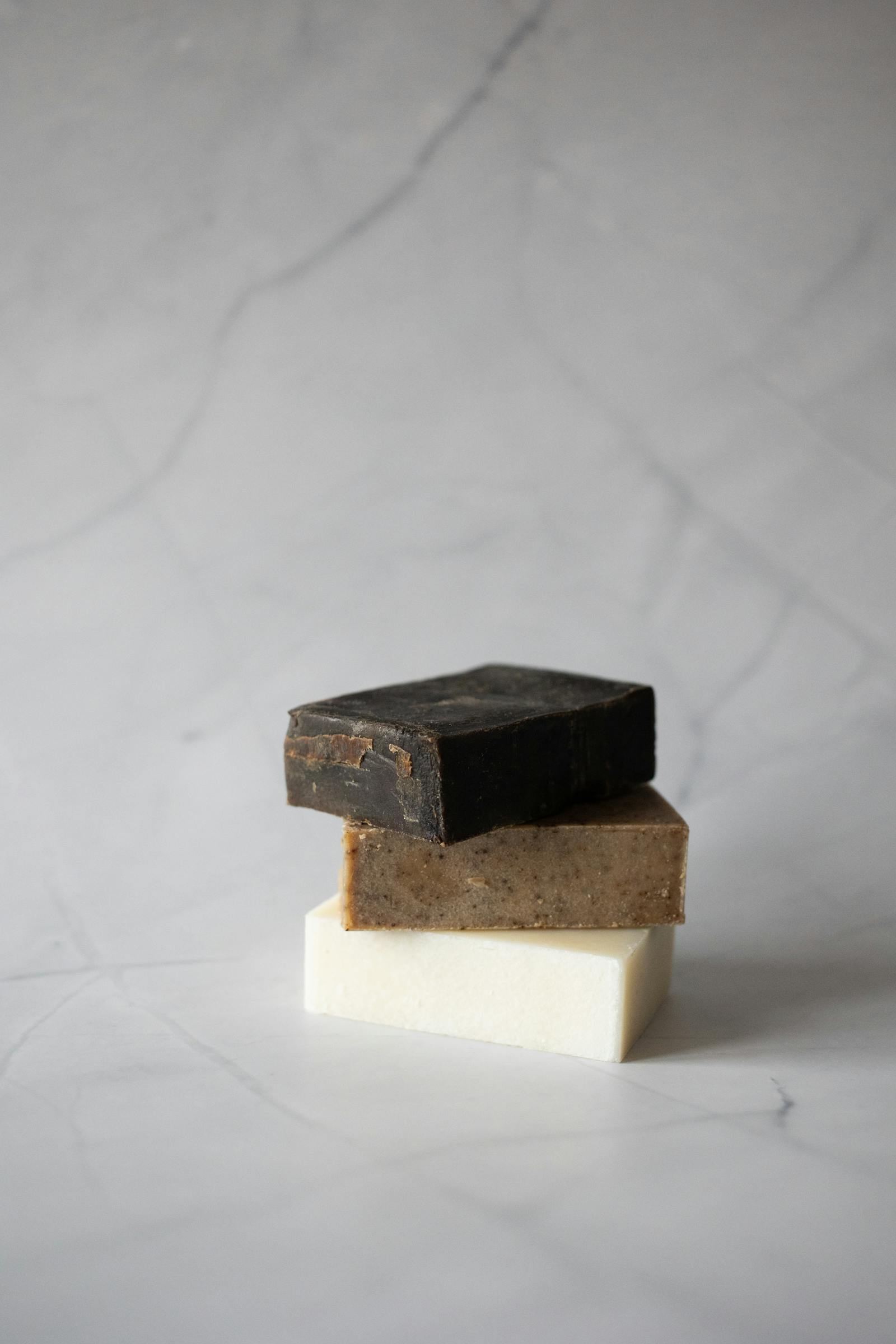 Curated retail set of small skincare goods on warm linen.